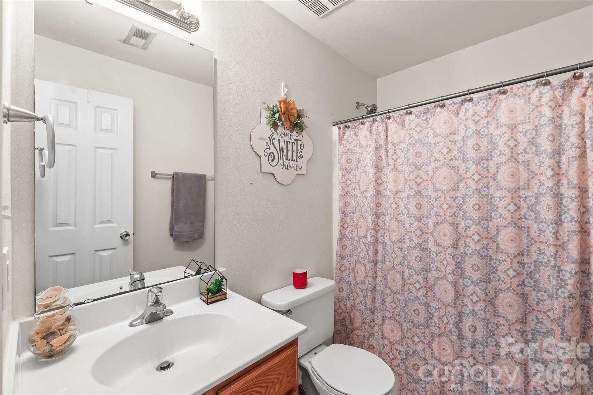 3983 Town Center Road Harrisburg, NC 28075 - Photo 11 of 13 a bathroom with a sink and a mirror