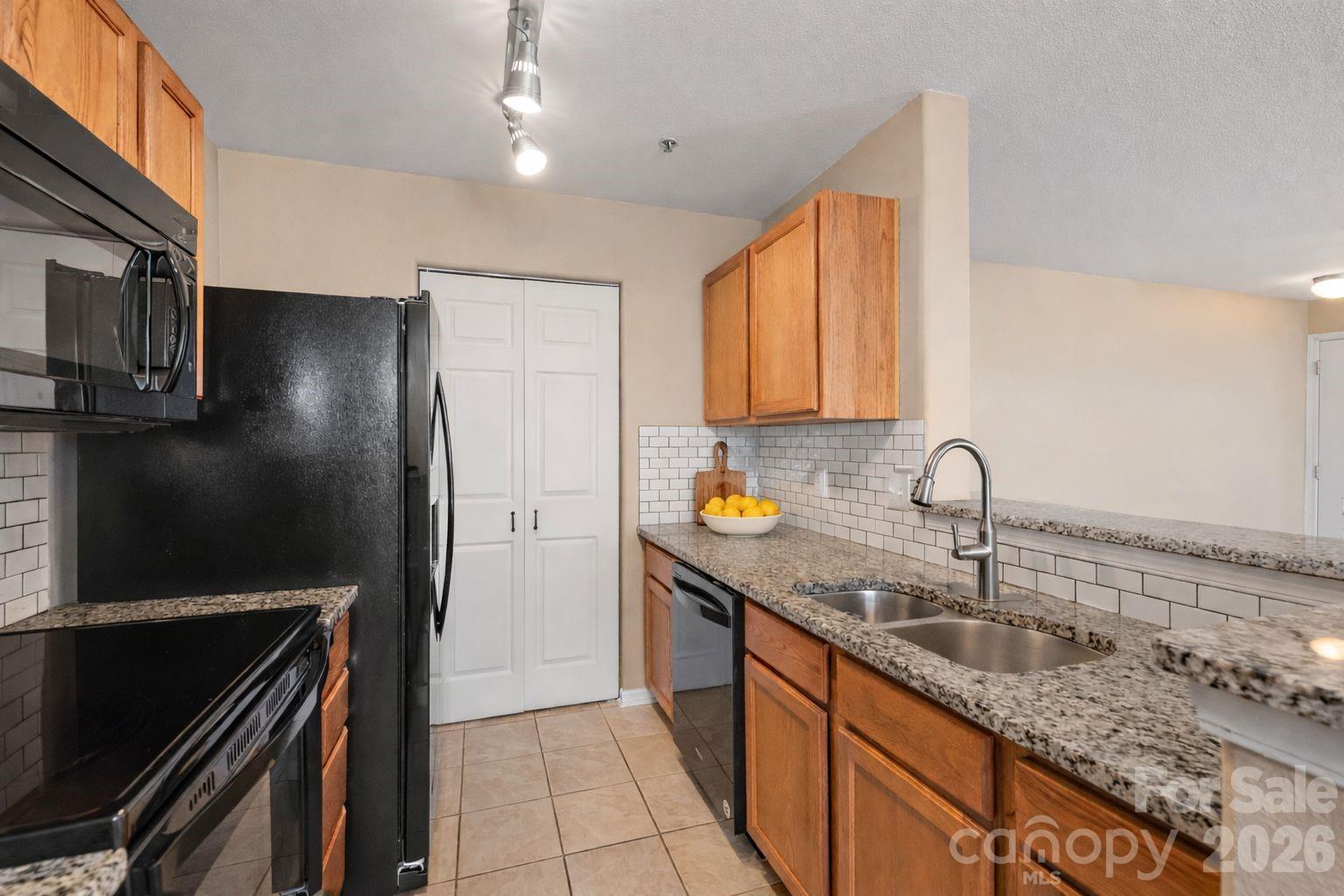 3983 Town Center Road Harrisburg, NC 28075 - Photo 4 of 13 a kitchen with stainless steel appliances granite countertop a sink stove and refrigerator