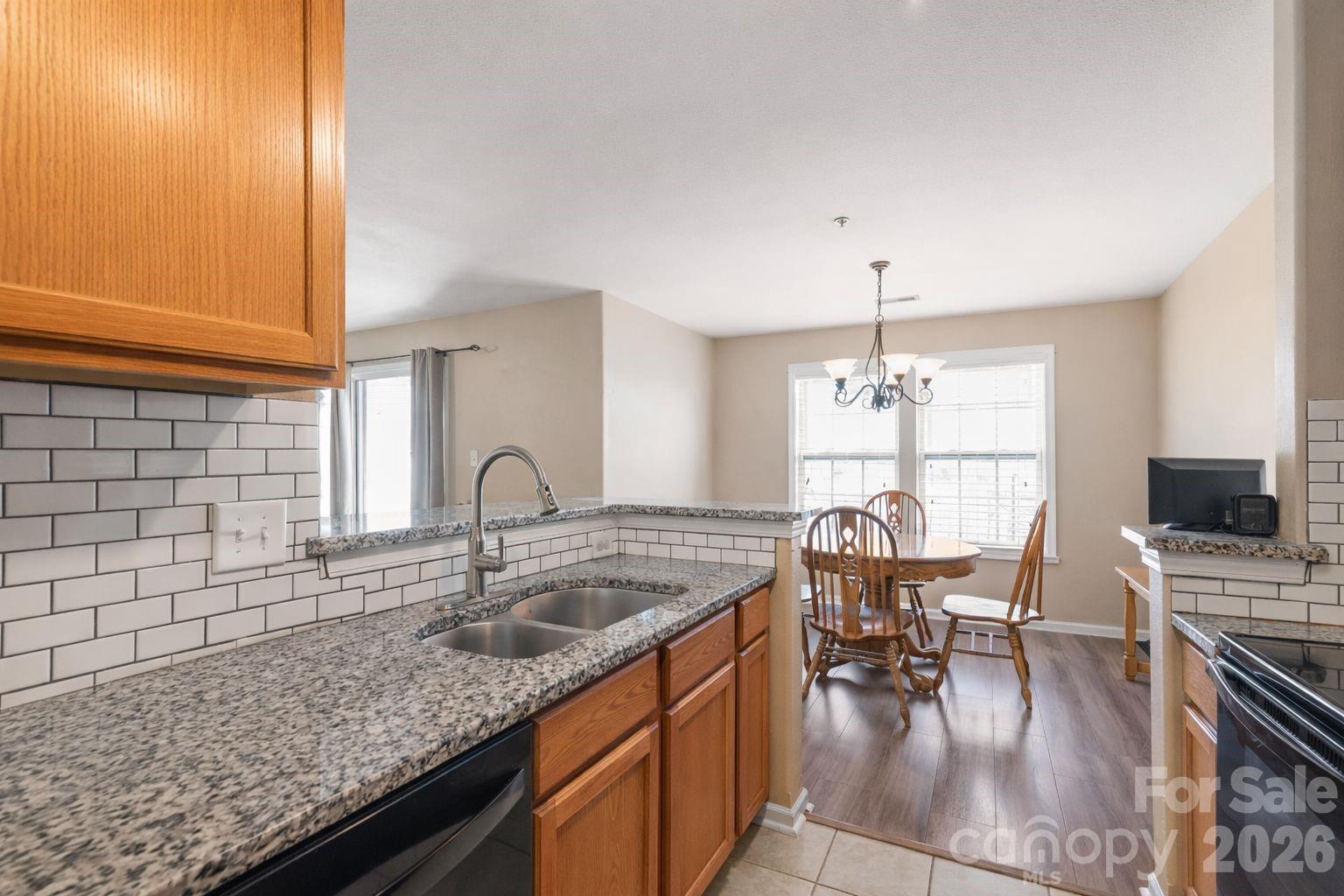 3983 Town Center Road Harrisburg, NC 28075 - Photo 5 of 13 a kitchen with a sink cabinets and dining table