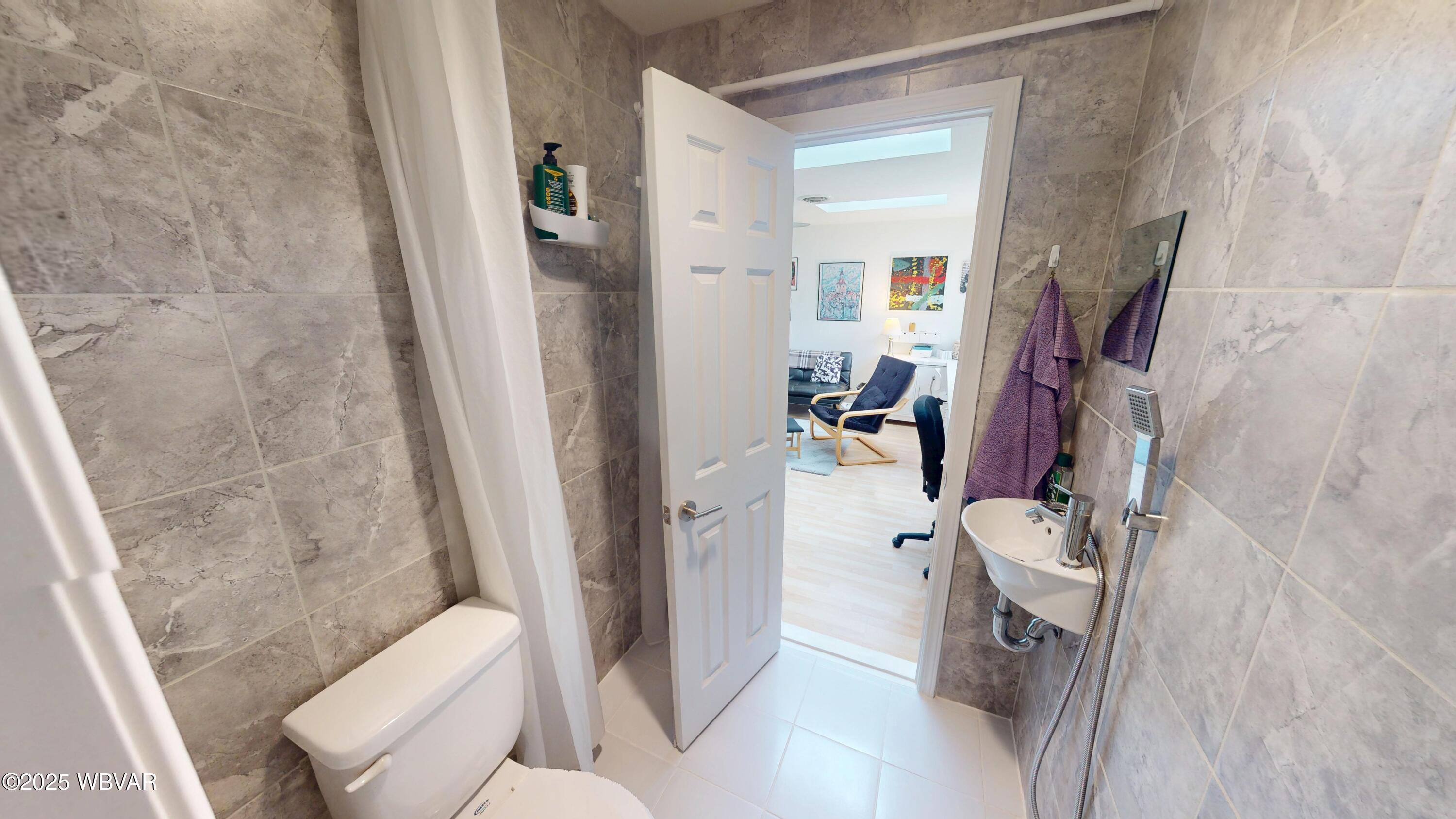 2446 Ritchey Street Williamsport, PA 17701 - Photo 13 of 17 The second bath is fully tiled and features a convenient shower and modern finishes & heated floor.