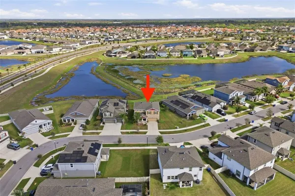 an aerial view of residential houses with outdoor space