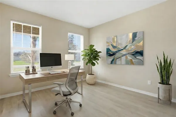 a view of a workspace with a window and potted plant