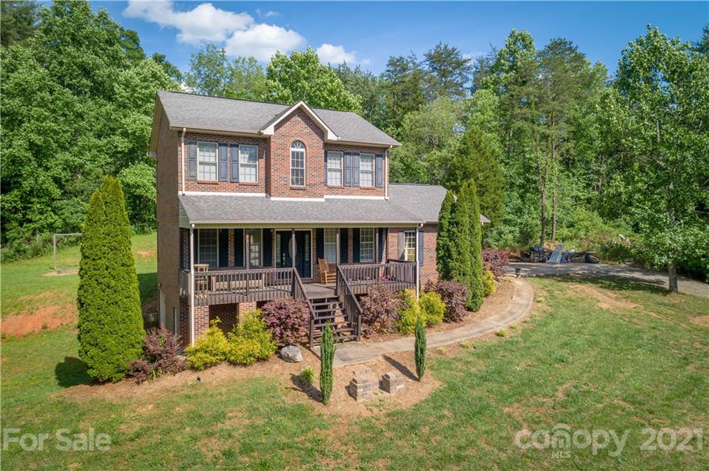 an aerial view of a house with a yard patio and furniture
