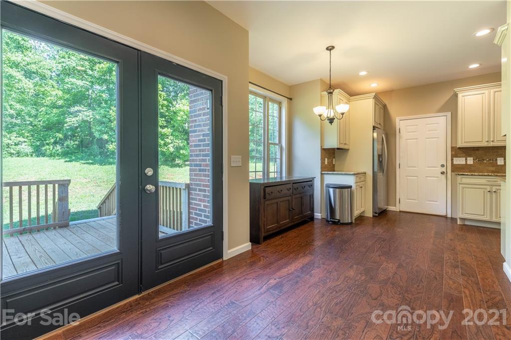 2341 Enola Road Morganton, NC 28655 - Photo 11 of 42 a open kitchen with granite countertop a refrigerator a sink a stove and wooden floors