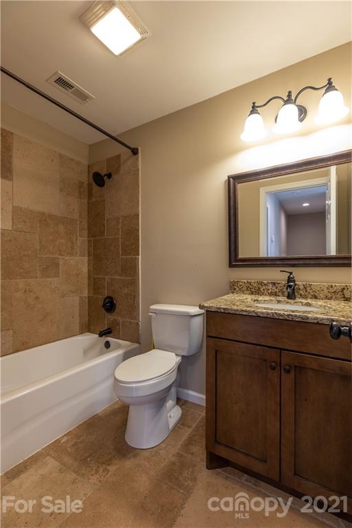 2341 Enola Road Morganton, NC 28655 - Photo 17 of 42 a bathroom with a toilet sink and mirror
