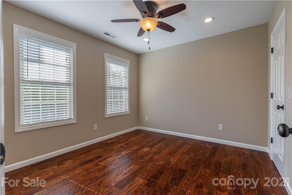 2341 Enola Road Morganton, NC 28655 - Photo 20 of 42 a bedroom with a bed and a chandelier fan