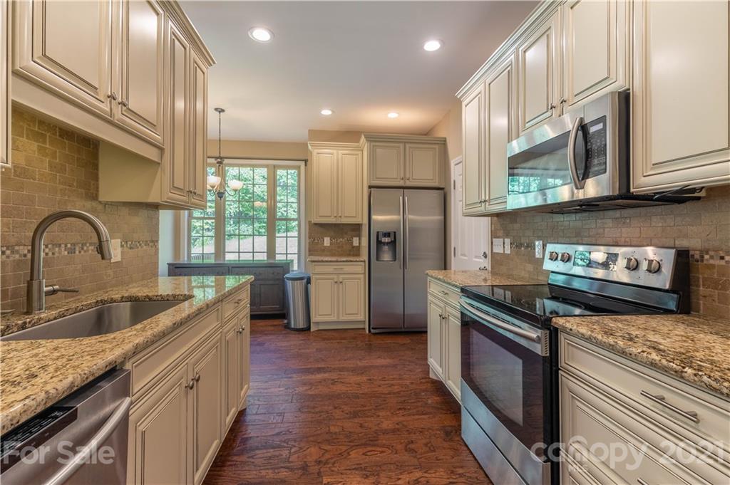 2341 Enola Road Morganton, NC 28655 - Photo 8 of 42 a kitchen with stainless steel appliances granite countertop a sink stove and refrigerator