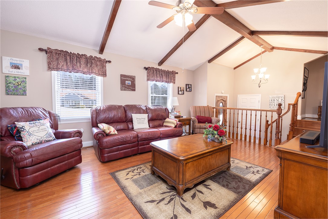 404 South Old Mill Road Seneca, SC 29678 - Photo 6 of 39 Warm wood-plank flooring and exposed ceiling beams define this inviting multi-level living area.