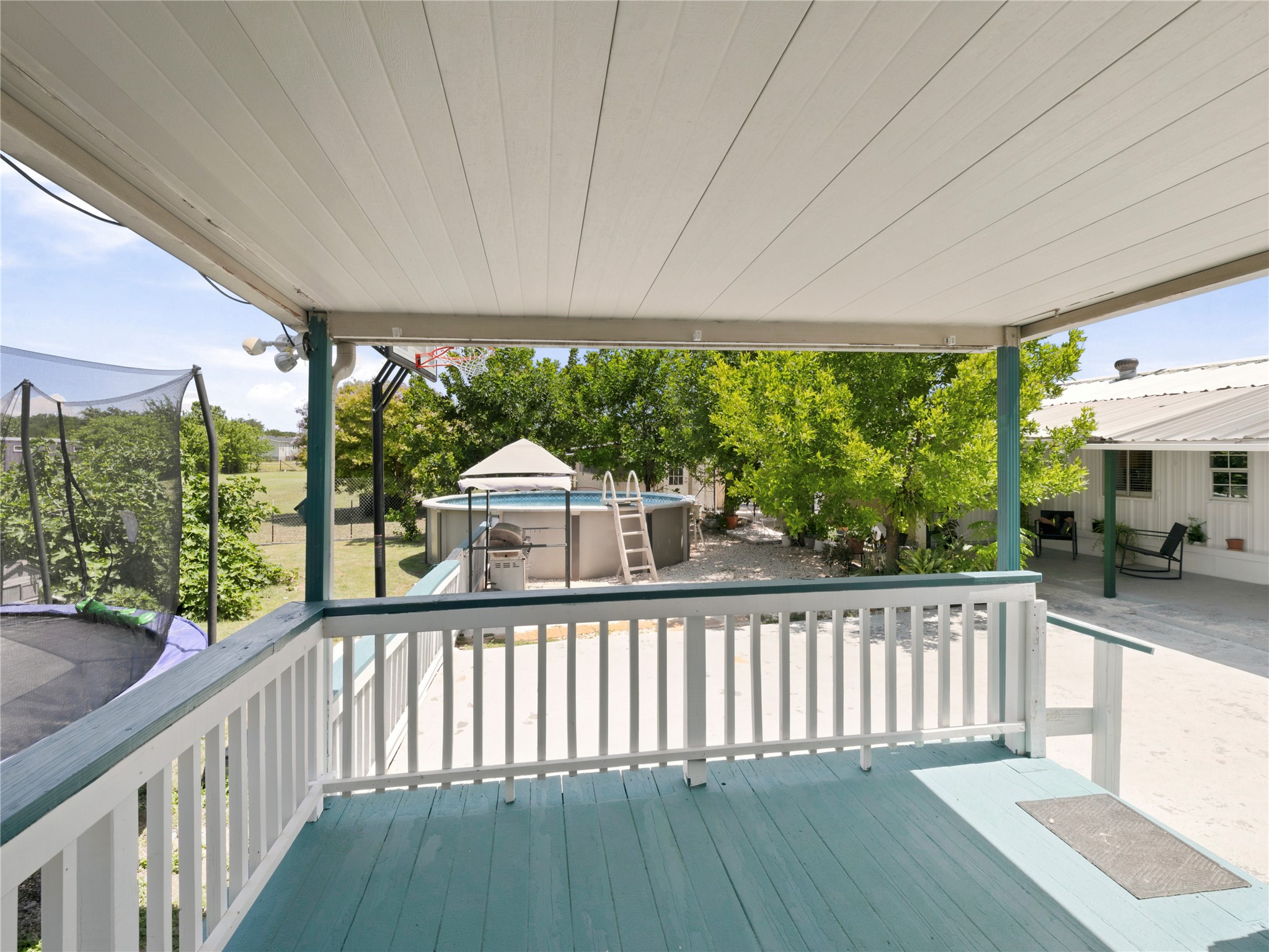 13241 2338th Road Georgetown, TX 78633 - Photo 23 of 26 An inviting covered patio offers delightful views of the yard and a refreshing pool.