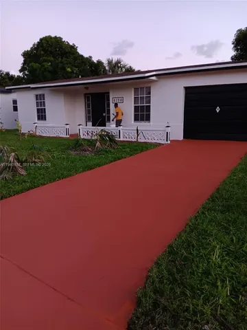 a front view of a house with garage and yard