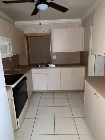 a kitchen with granite countertop a sink and a stove