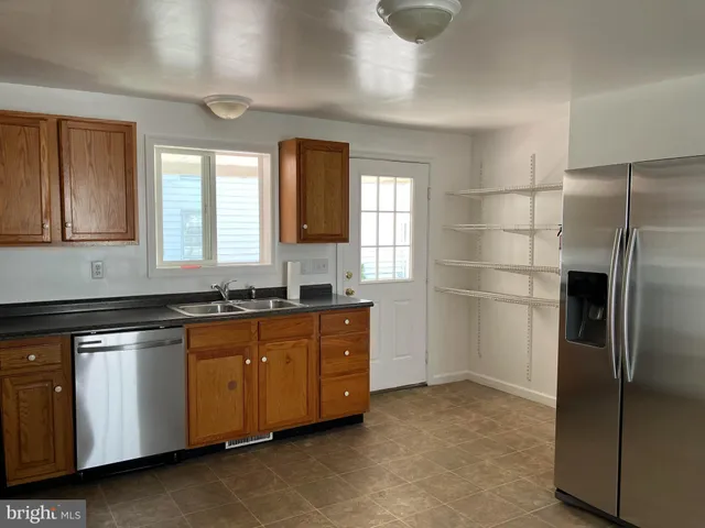 a kitchen with a refrigerator and window