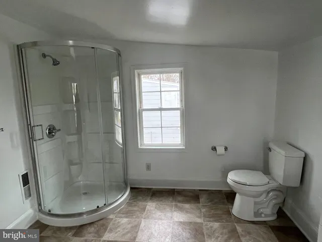 a bathroom with a shower and a toilet
