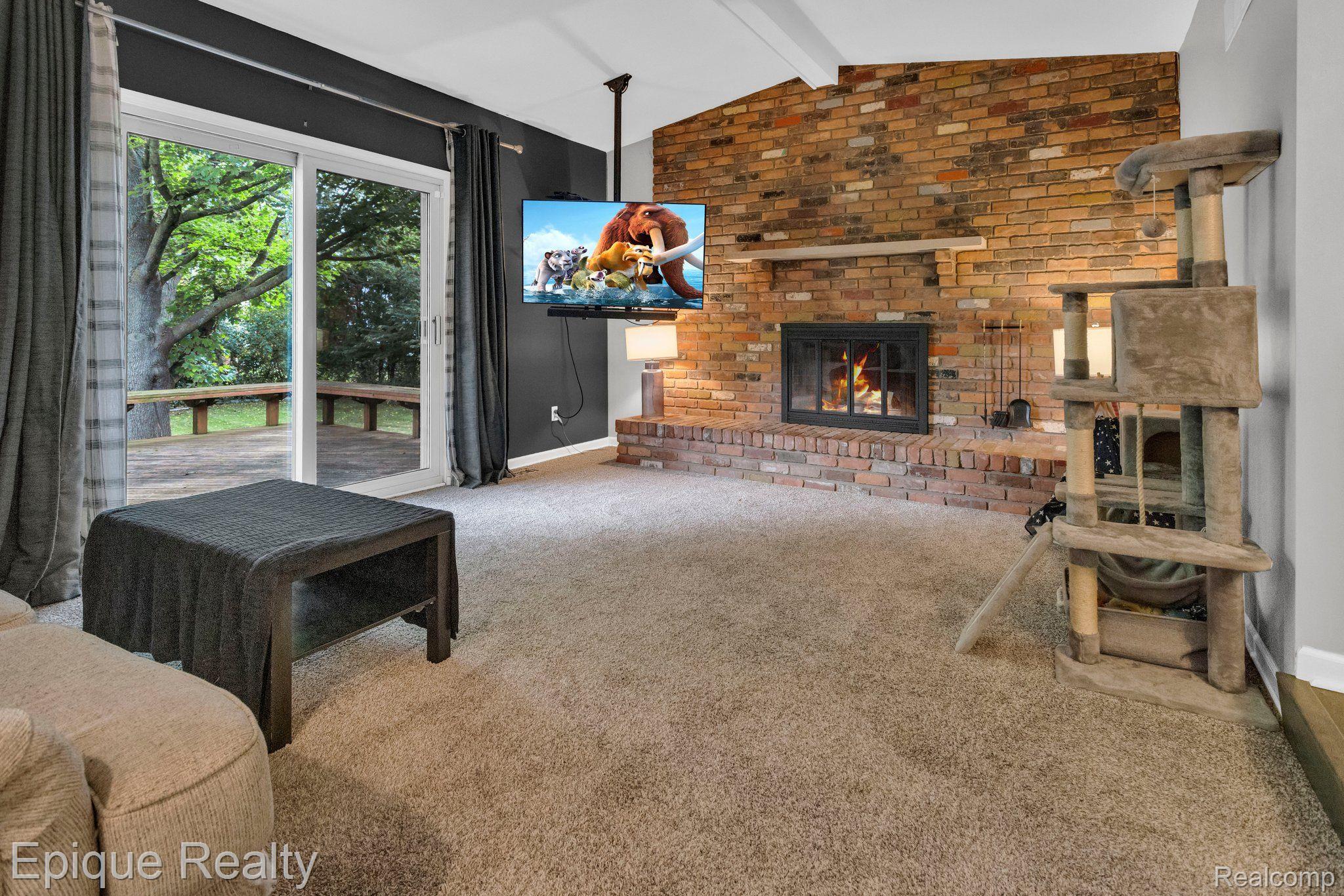 35973 Smithfield Road Farmington, MI 48335 - Photo 13 of 30 Family Room- Natural fireplace & doorwall to deck