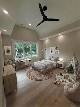 a bedroom with furniture and a large window