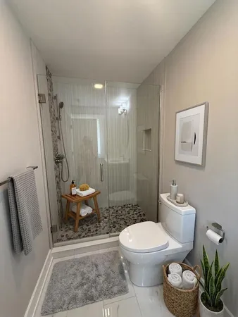 a bathroom with a toilet a sink and a shower