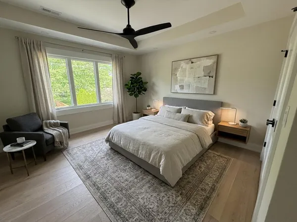 a bedroom with a bed a couch and a window