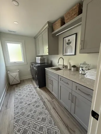 a bathroom with a double vanity sink a mirror and a toilet