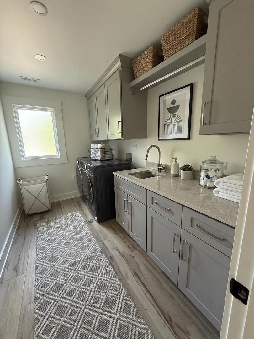 5535 Brookbank Road Downers Grove, IL 60516 - Photo 18 of 22 a bathroom with a double vanity sink a mirror and a toilet