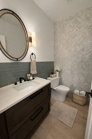 a bathroom with a sink mirror and toilet