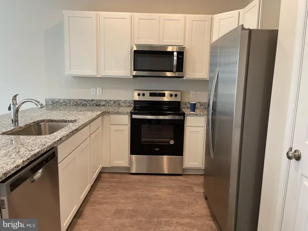 a kitchen with a stove microwave and sink