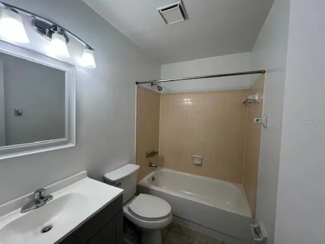 a bathroom with a sink mirror bathtub and toilet