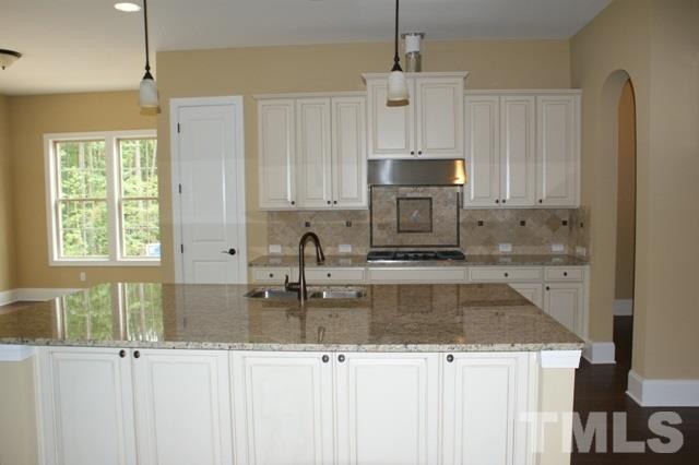 7504 Pinaster Place, Unit 54 Raleigh, NC 27613 - Photo 1 of 1 a kitchen with stainless steel appliances granite countertop a sink a stove and a refrigerator