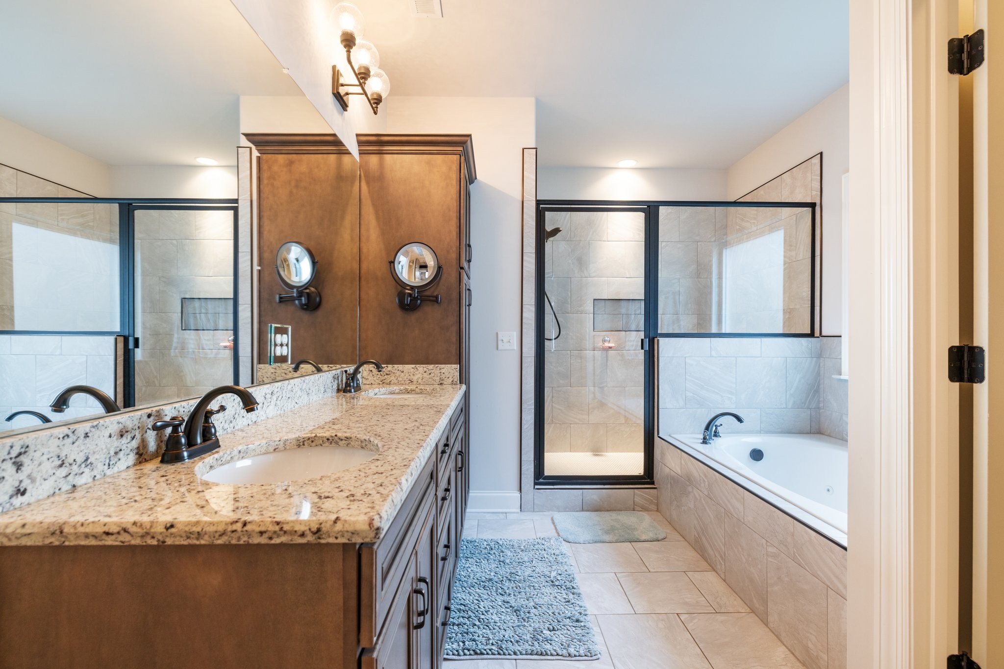 305 McClaran Place Murfreesboro, TN 37129 - Photo 11 of 23 a bathroom with a granite countertop sink a mirror and shower