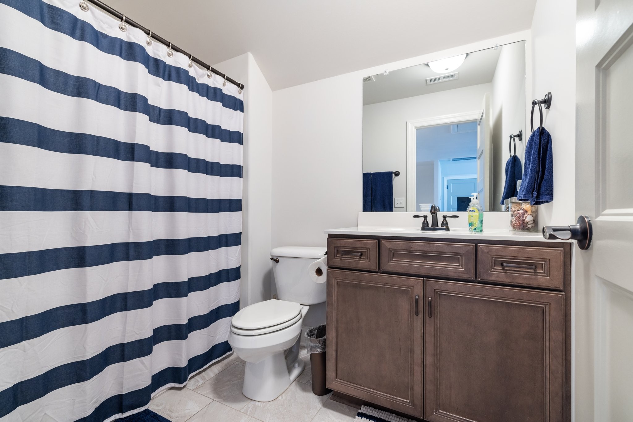 305 McClaran Place Murfreesboro, TN 37129 - Photo 21 of 23 a bathroom with a sink a toilet a mirror and shower curtain