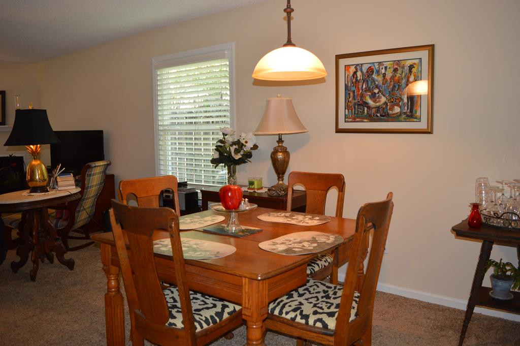 108 Raintree Court Aiken, SC 29803 - Photo 9 of 18 a view of a dining room with furniture window and wooden floor
