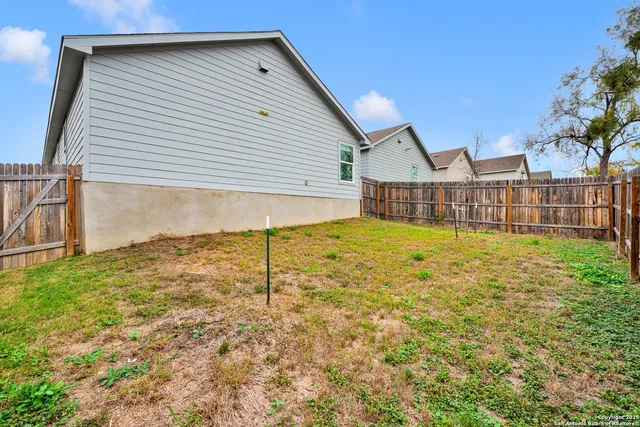 a view of a house with a yard and sitting area