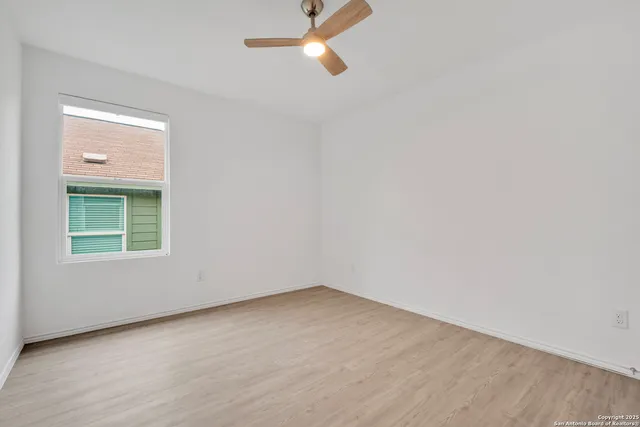 an empty room with windows and entrance