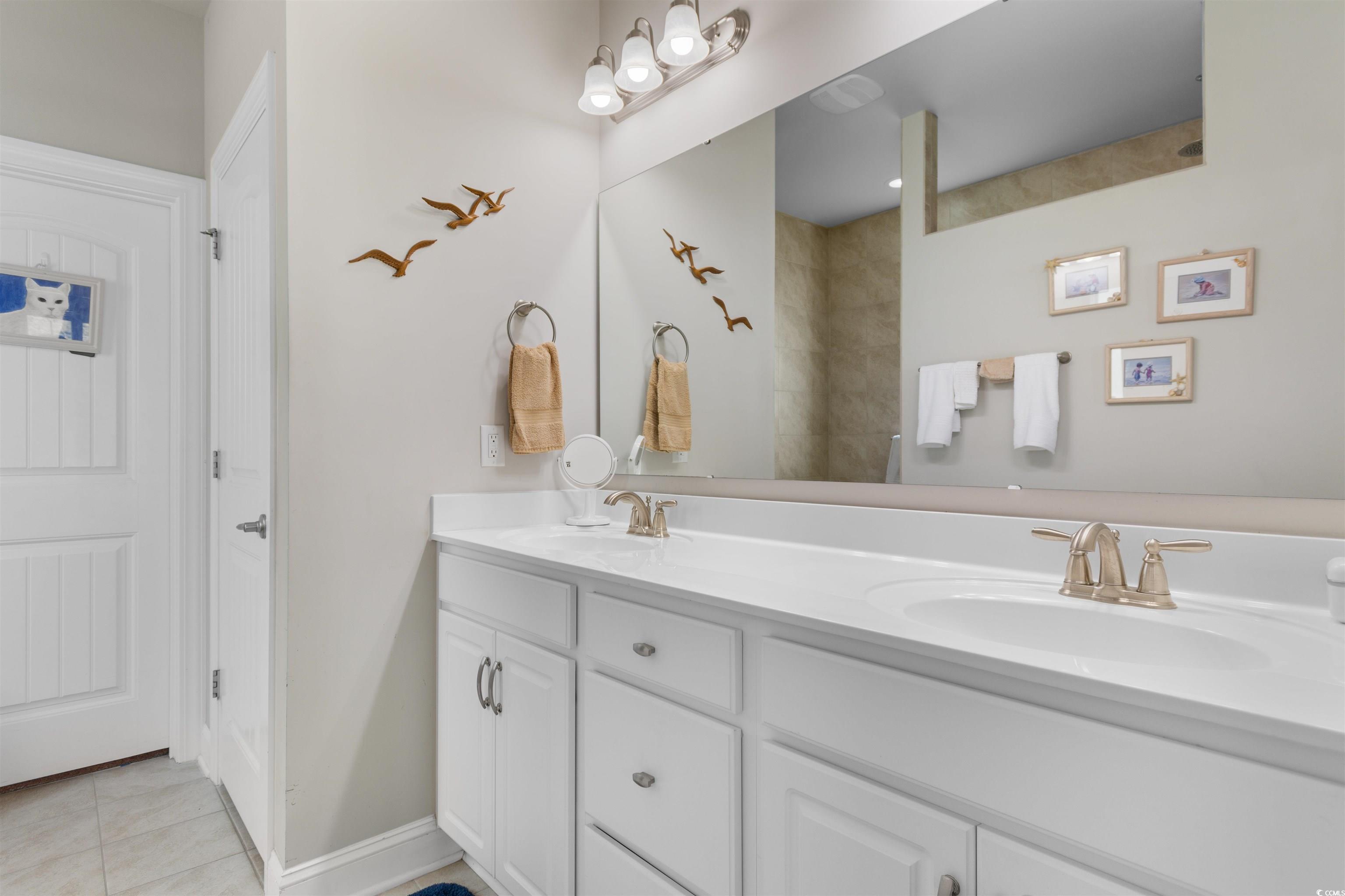 765 Berkshire Avenue Myrtle Beach, SC 29577 - Photo 18 of 40 Bathroom with double vanity and tile patterned floors