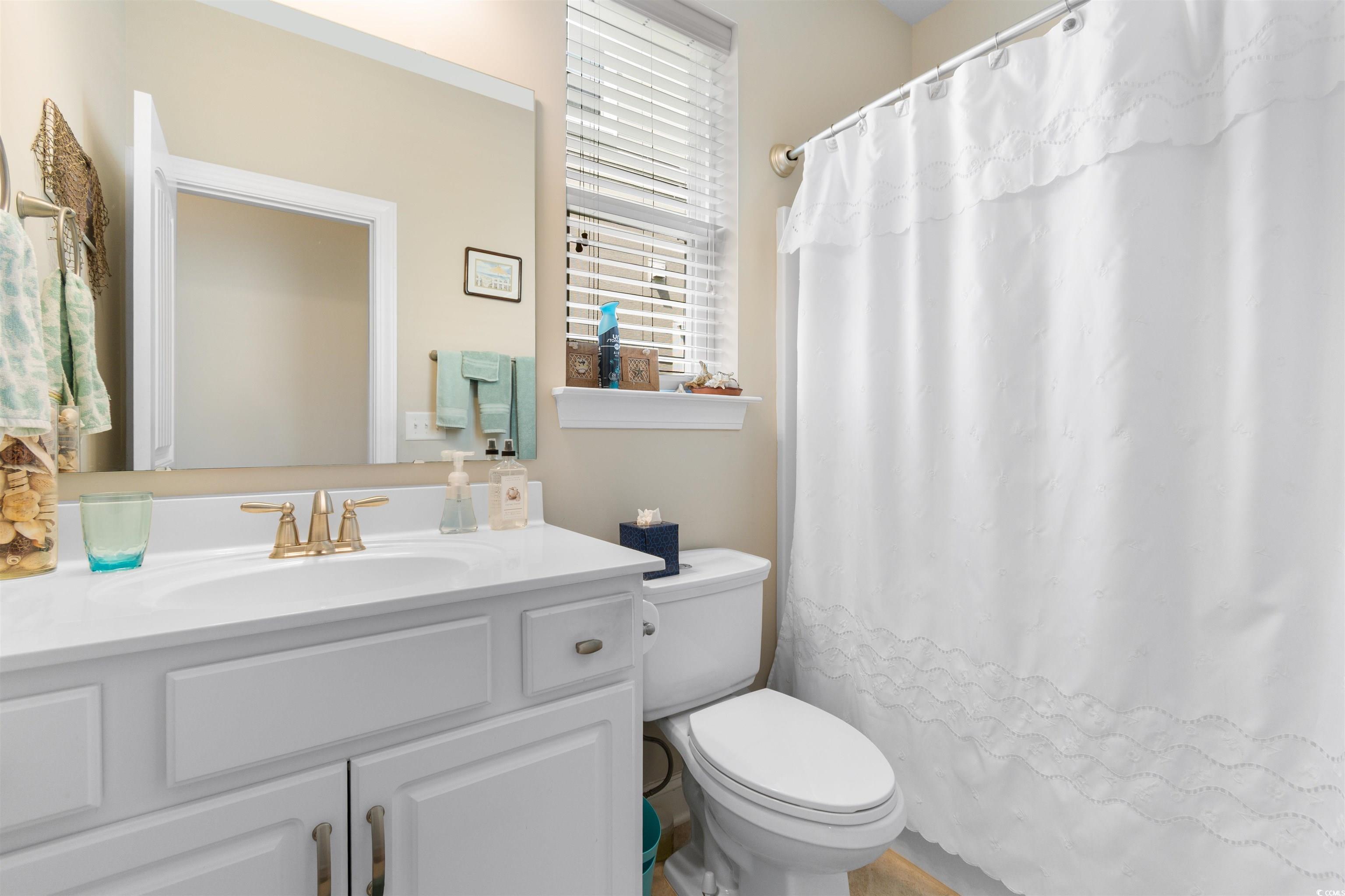 765 Berkshire Avenue Myrtle Beach, SC 29577 - Photo 23 of 40 Bathroom with toilet, vanity, and curtained shower