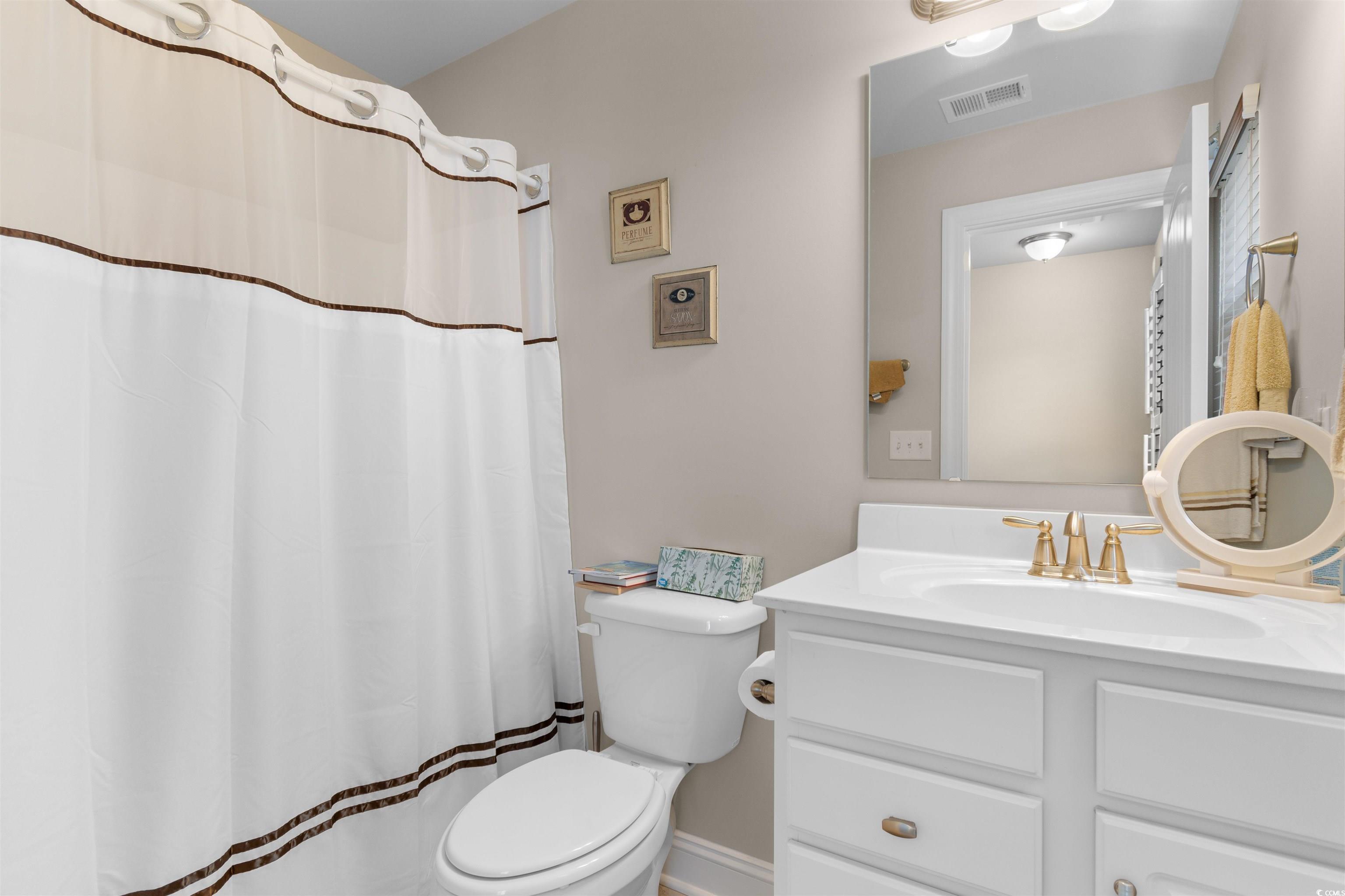765 Berkshire Avenue Myrtle Beach, SC 29577 - Photo 27 of 40 Full bath featuring toilet, vanity, and curtained shower