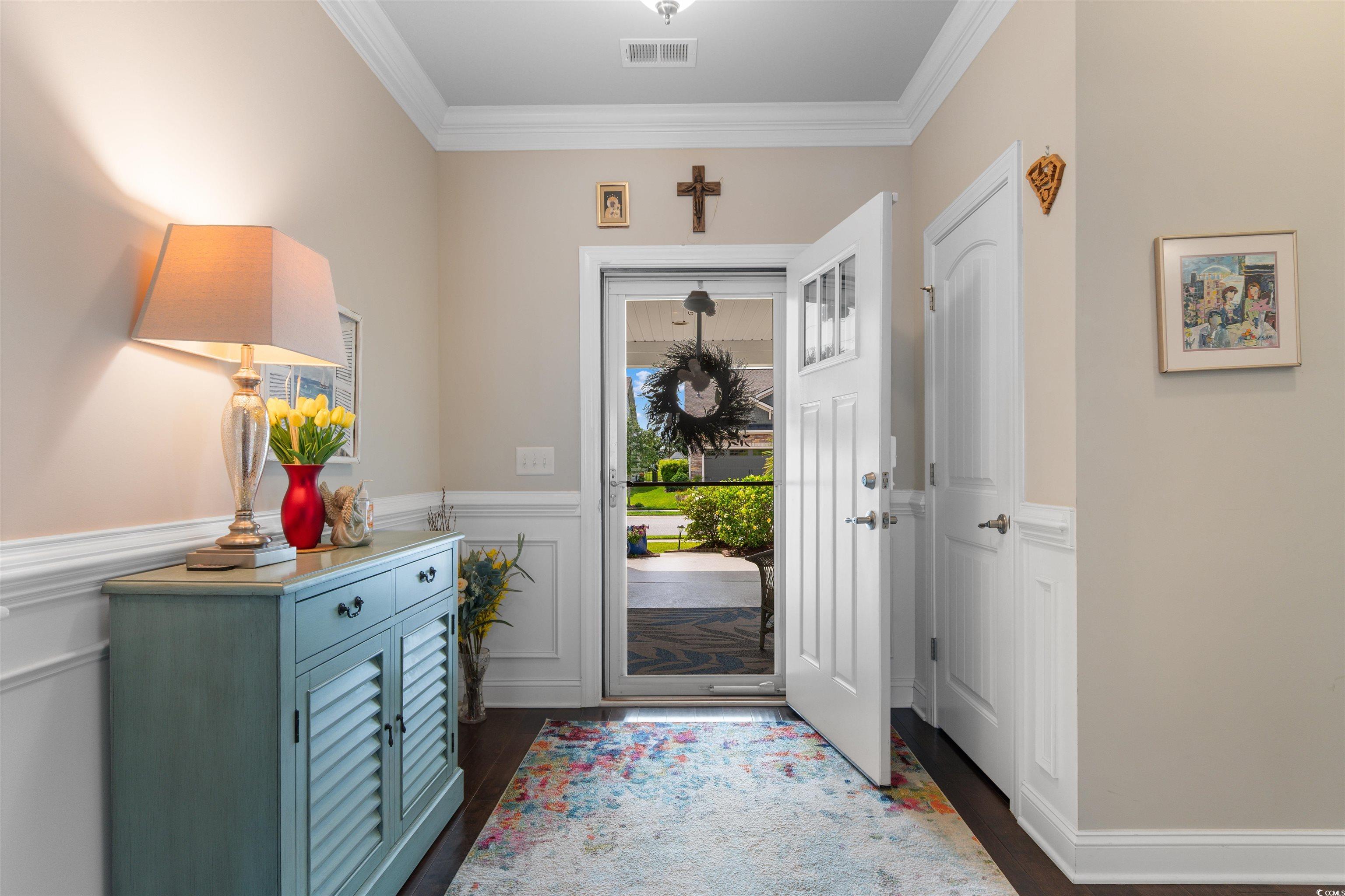 765 Berkshire Avenue Myrtle Beach, SC 29577 - Photo 5 of 40 Entryway with crown molding, dark wood-style floors, and wainscoting
