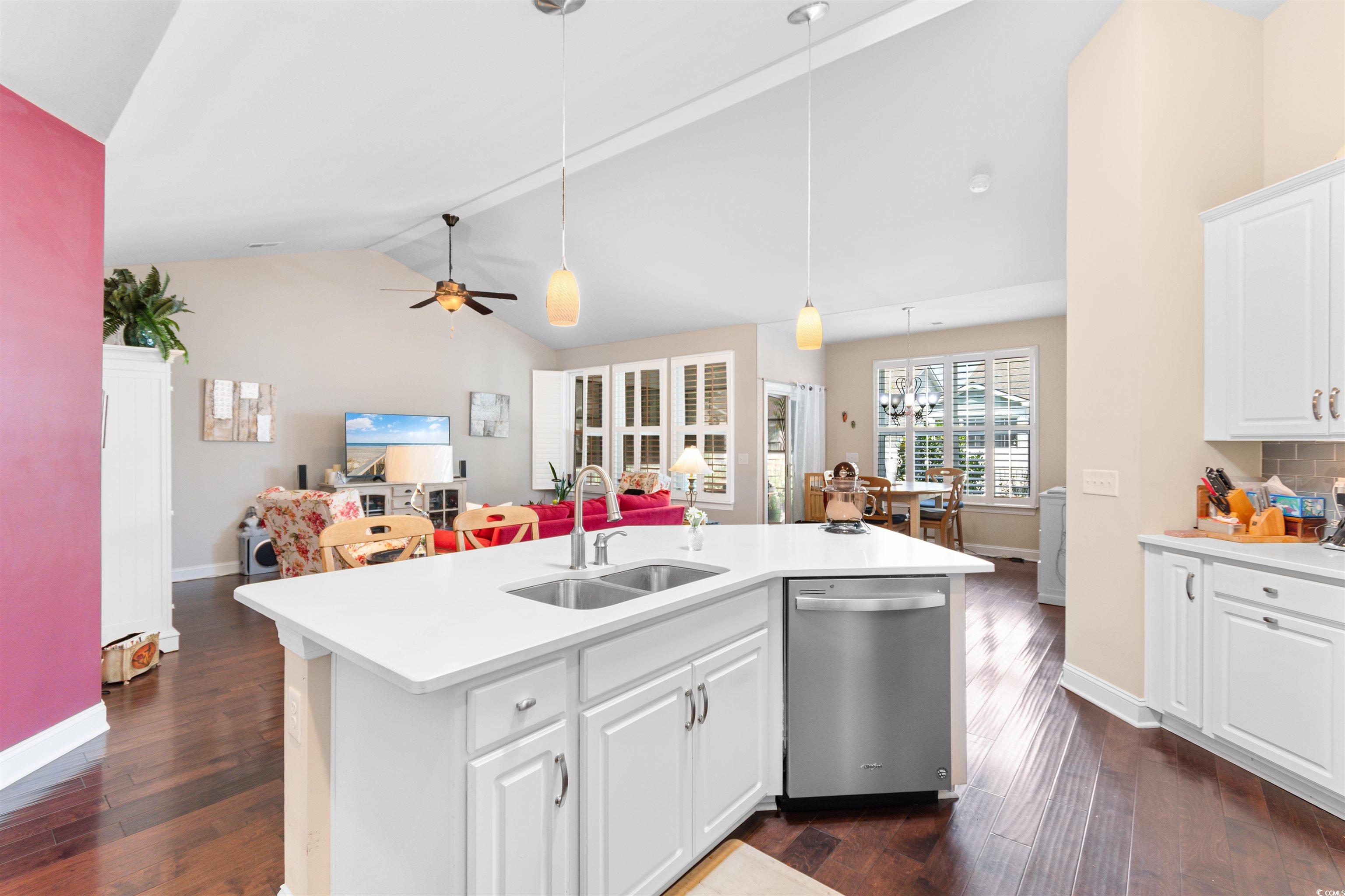 765 Berkshire Avenue Myrtle Beach, SC 29577 - Photo 8 of 40 Kitchen featuring stainless steel dishwasher, a sink, lofted ceiling, dark wood-type flooring, and light countertops