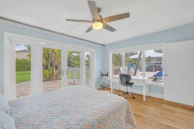 a bathroom with a granite countertop sink a toilet a mirror and shower