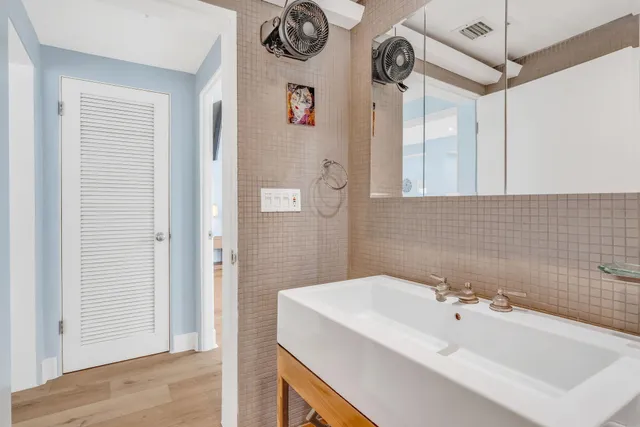 a bedroom with a bed and a large window with chair