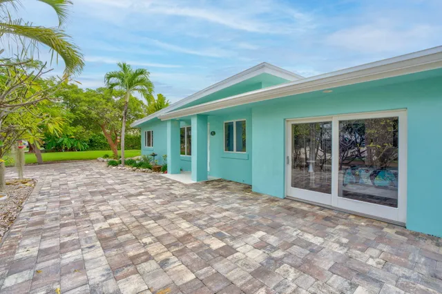 a bedroom with a bed and a lamp next to a window