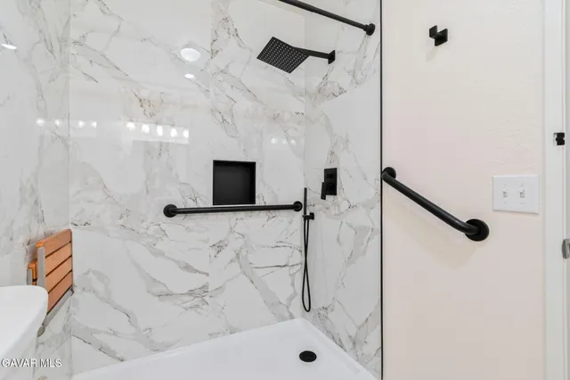 a bathroom with a bathtub and a shower