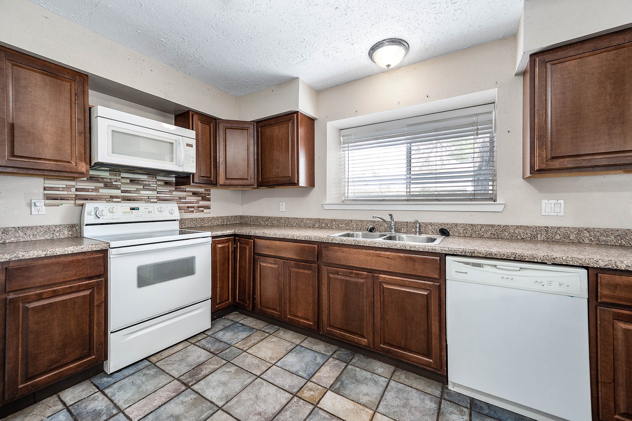4734 Lost Lake Lane Spring, TX 77388 - Photo 11 of 23 a kitchen with stainless steel appliances granite countertop a stove sink and cabinets
