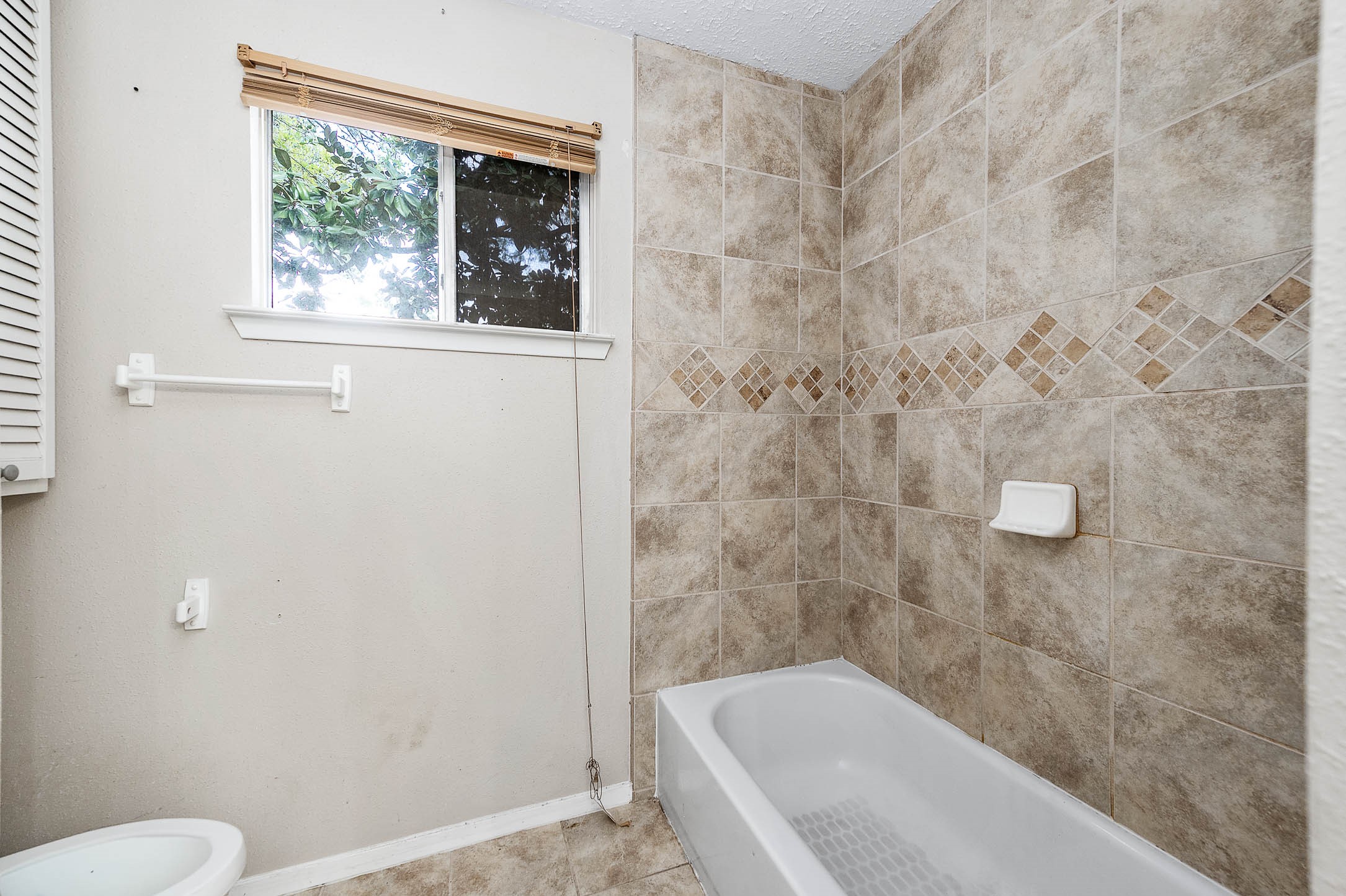 4734 Lost Lake Lane Spring, TX 77388 - Photo 19 of 23 a bathroom with a bathtub and window