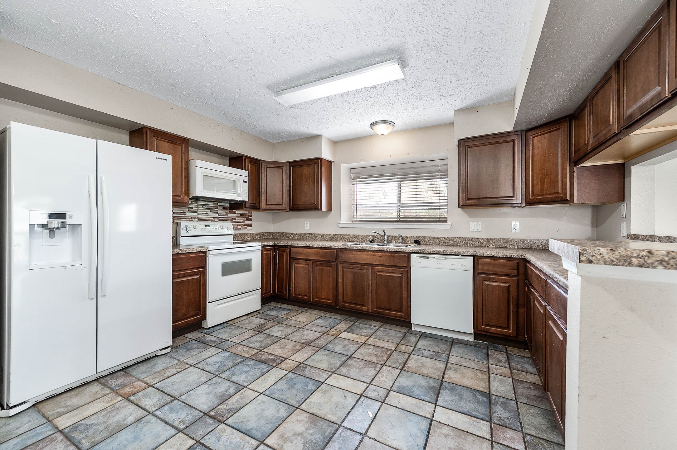 4734 Lost Lake Lane Spring, TX 77388 - Photo 9 of 23 a kitchen with stainless steel appliances granite countertop a stove sink and cabinets