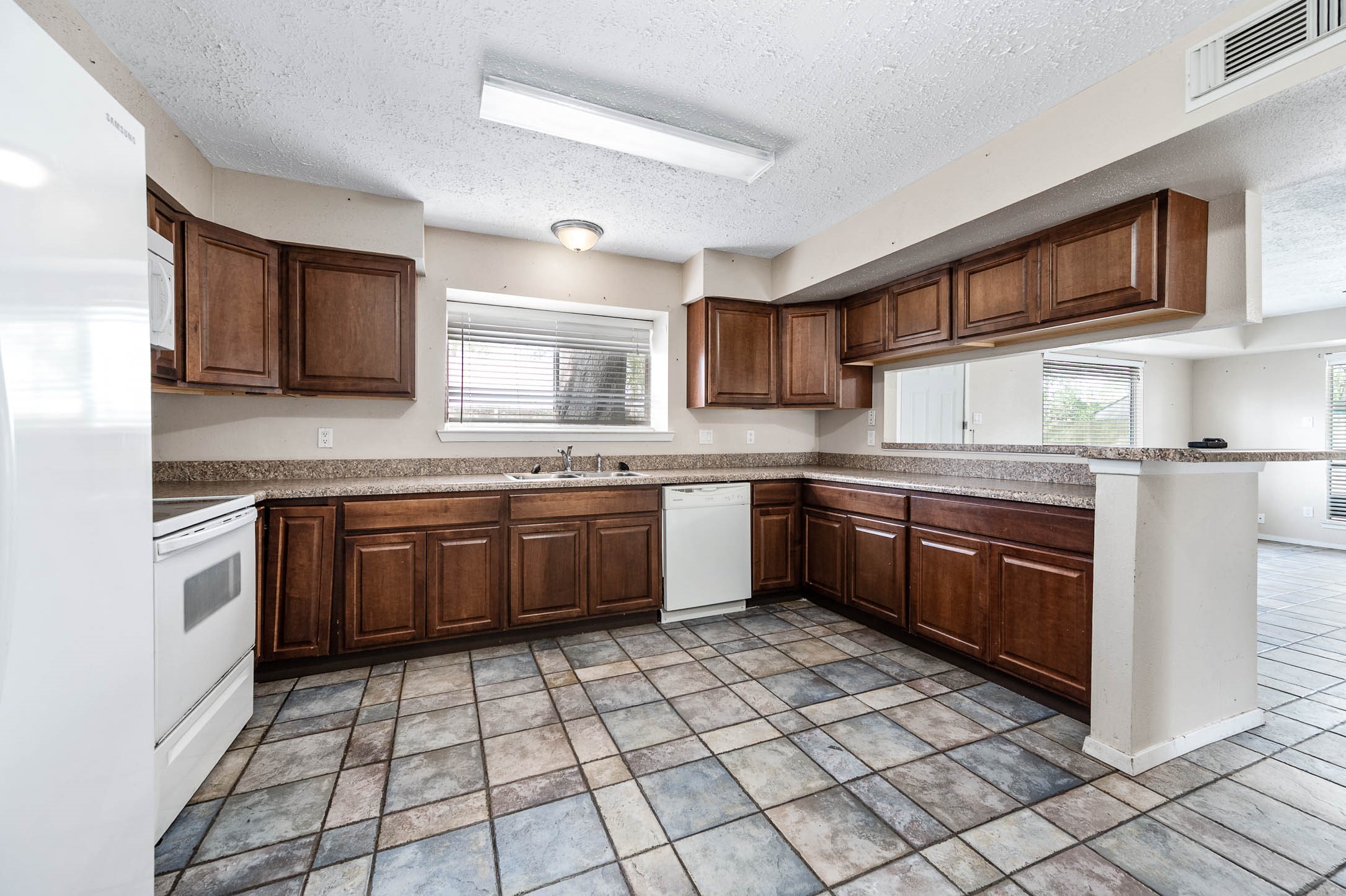 4734 Lost Lake Lane Spring, TX 77388 - Photo 10 of 23 a kitchen with stainless steel appliances granite countertop a stove sink cabinets and window