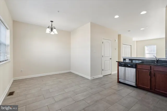 an empty room with kitchen and sink