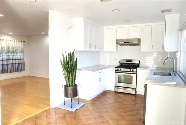 a kitchen with a sink stove and cabinets