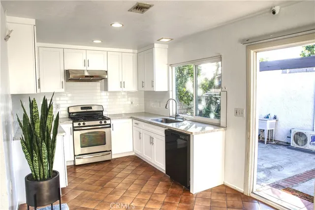 a kitchen with a stove a sink and a refrigerator
