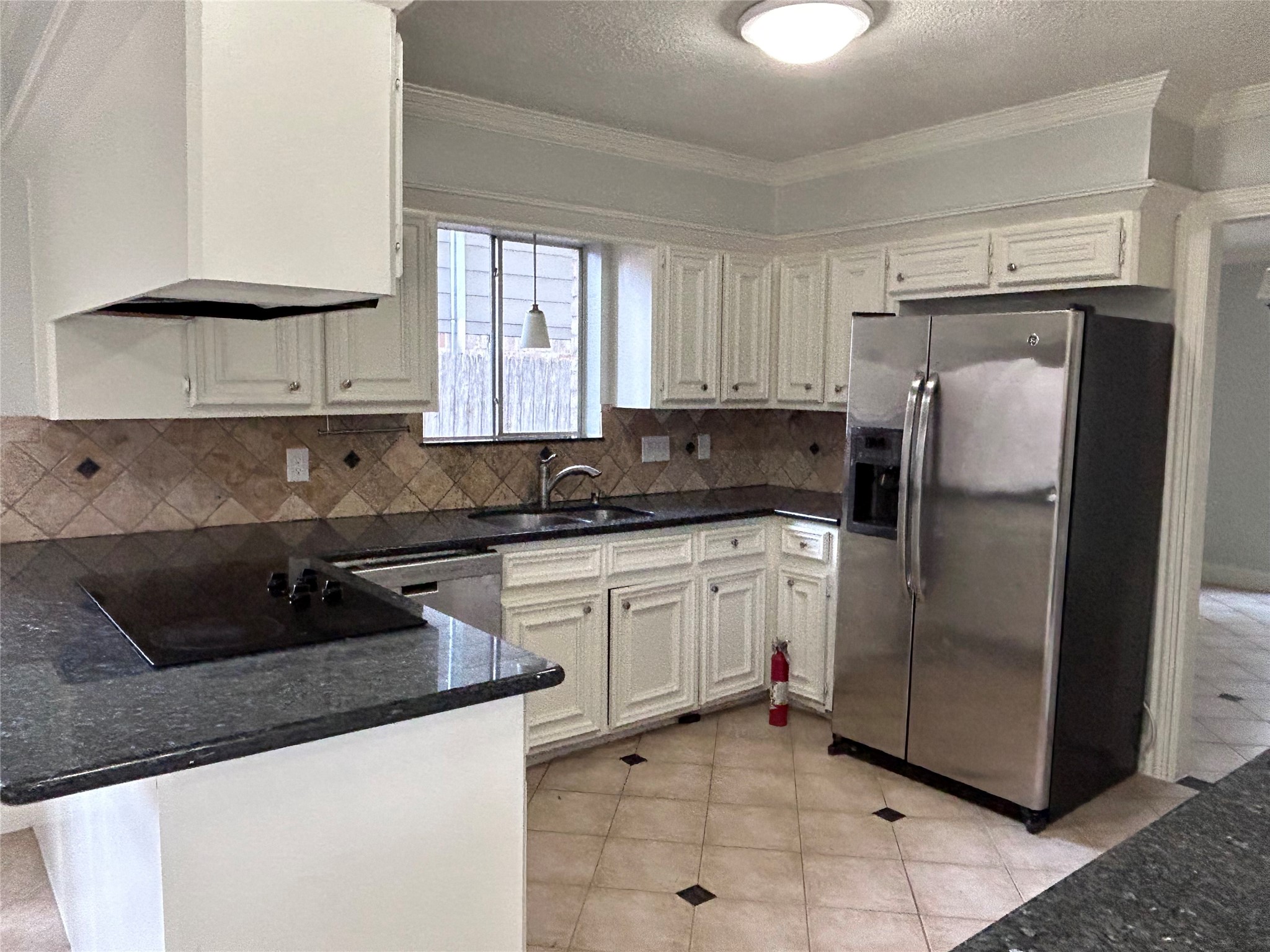 706 Houghton Road Katy, TX 77450 - Photo 3 of 14 a kitchen with stainless steel appliances granite countertop a refrigerator sink and cabinets