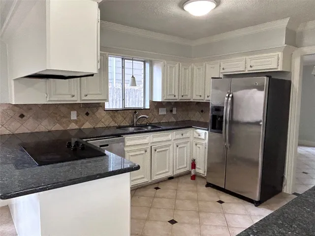 a kitchen with stainless steel appliances granite countertop a refrigerator sink and cabinets